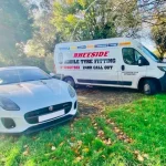 Emergency roadside tyre replacement on a Jaguar